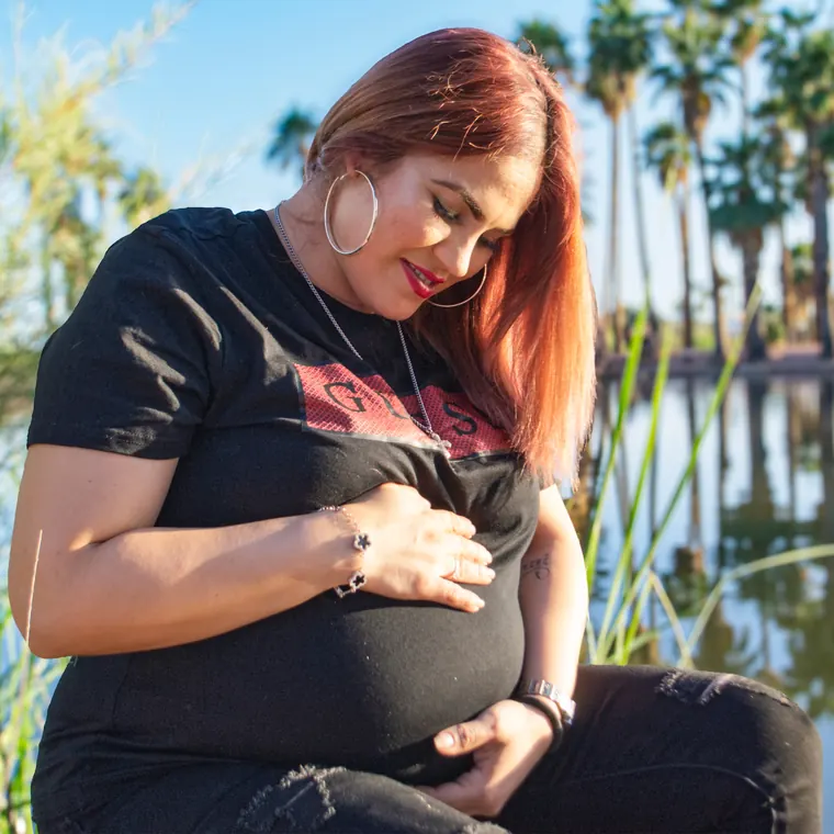 A mother in the last weeks of pregnancy, outdoors by a lake in Arizona